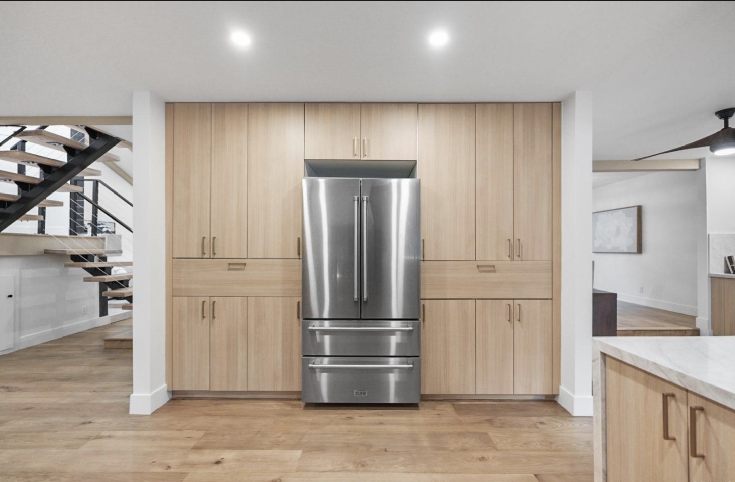 Kitchen with natural wood cabinetry in a Cresta-managed home